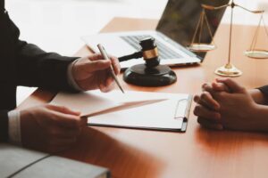 Lawyer consulting with a businessman during a team meeting, representing law and legal services.